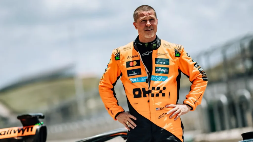 Brad Pitt stands next to the McLaren MCL60 Formula 1 car, 2025