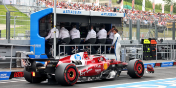 Carlos Sainz [on pit wall] was forced out of Ferrari in favour of Lewis Hamilton
