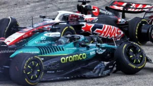 Stroll and Ocon make contact at Turn 1 during the Sprint at the US Grand Prix, debris scattering as both cars slide wide into the runoff area.