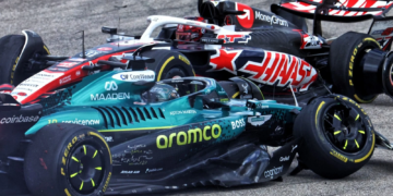 Stroll and Ocon make contact at Turn 1 during the Sprint at the US Grand Prix, debris scattering as both cars slide wide into the runoff area.