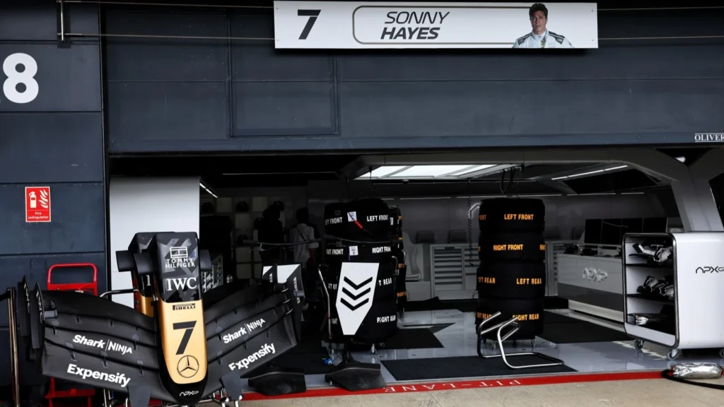 The fictional APXGP team garage during filming of F1: The Movie