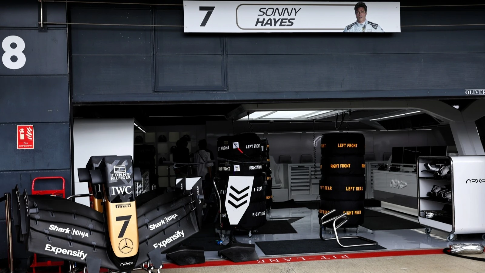 The fictional APXGP team garage during filming of F1: The Movie
