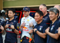 Max Verstappen has been praised by Honda president Koji Watanabe [front, third from right]