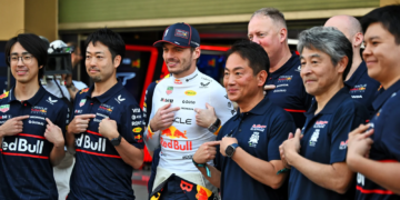 Max Verstappen has been praised by Honda president Koji Watanabe [front, third from right]