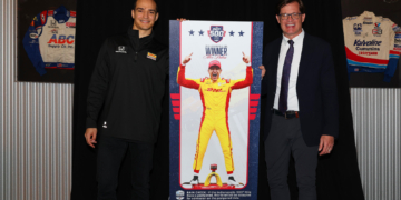 Alex Palou stands with Doug Boles next to this year's ticket design. Photo: IndyCar - Chris Owens