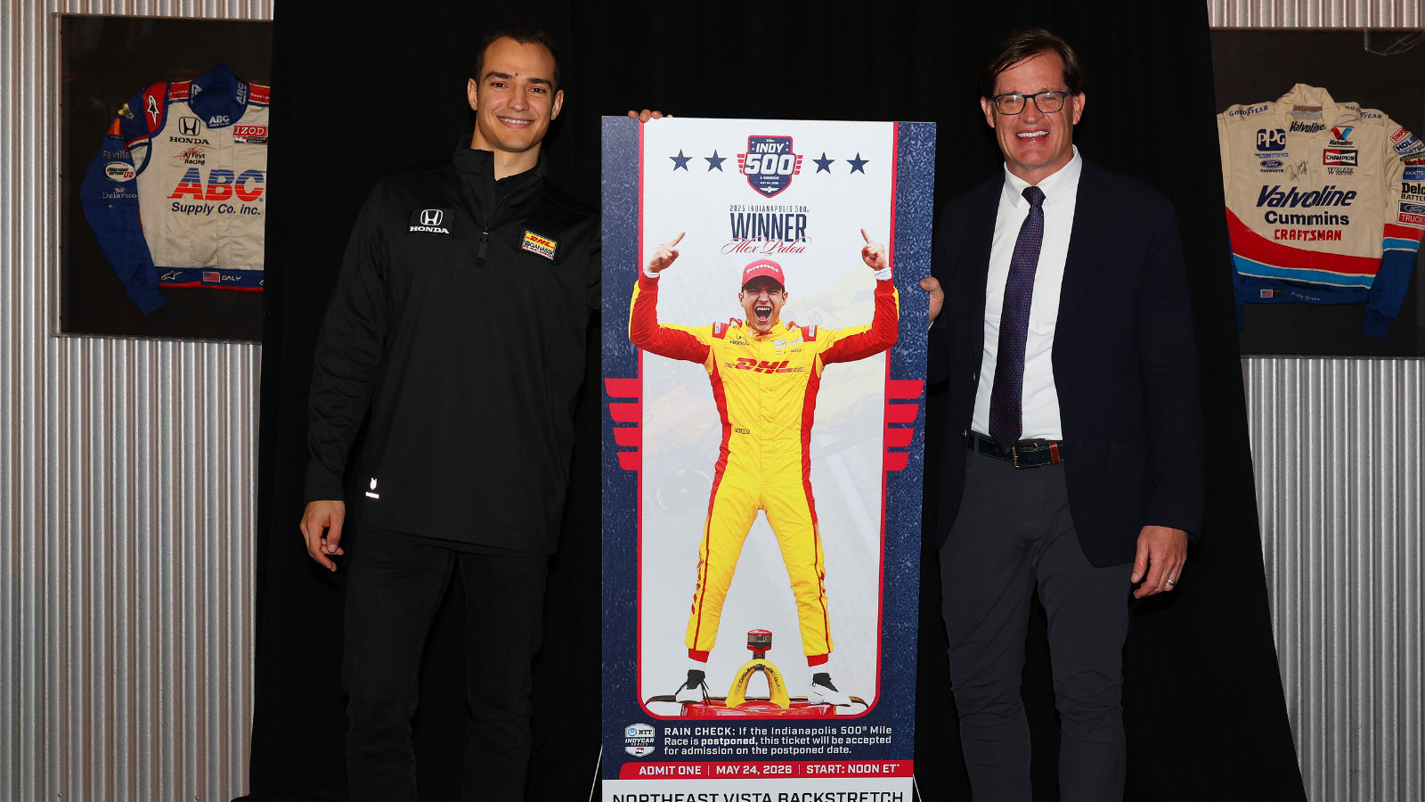 Alex Palou stands with Doug Boles next to this year's ticket design. Photo: IndyCar - Chris Owens