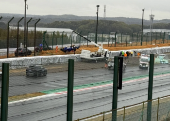The wreckage of Luke Browning's Super Formula Car is visible behind the Tecpro barrier
