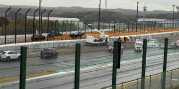 The wreckage of Luke Browning's Super Formula Car is visible behind the Tecpro barrier