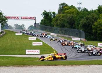 The field piles through Turn 3 on the first lap. Photo: Kevin Dejewski