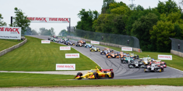 The field piles through Turn 3 on the first lap. Photo: Kevin Dejewski