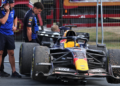 Max Verstappen's Red Bull is towed away after it beached him in the gravel towards the finish of the race at Silverstone